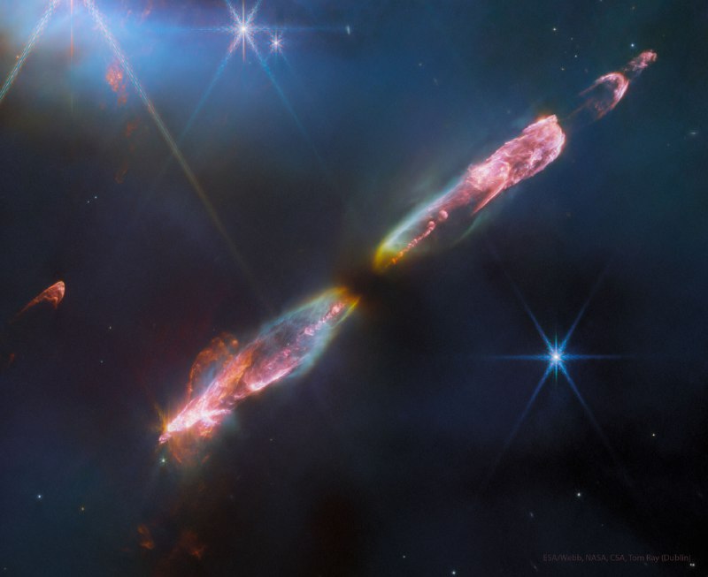 Do stars always create jets as they form? No one is sure. As a gas cloud gravitationally contracts, it forms a disk that can spin too fast to continue contracting into a protostar.  Theorists hypothesize that this spin can be reduced by expelling jets. This speculation coincides with known Herbig-Haro (HH) objects, young stellar objects seen to emit jets -- sometimes in spectacular fashion. Pictured is Herbig-Haro 211, a young star in formation recently imaged by the Webb Space Telescope (JWST) in infrared light and in great detail.  Along with the two narrow beams of particles, red shock waves can be seen as the outflows impact existing interstellar gas. The jets of HH 221 will likely change shape as they brighten and fade over the next 100,000 years, as research into the details of star formation continues.