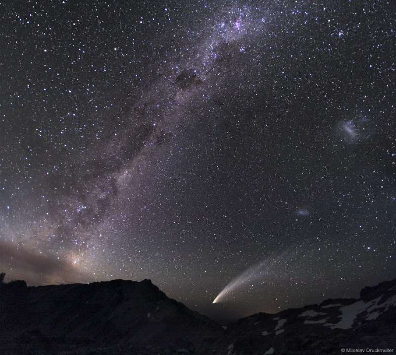 Diffuse starlight and dark nebulae along the southern Milky Way arc over the horizon and sprawl diagonally through this gorgeous nightscape. The breath-taking mosaic spans a wide 100 degrees, with the rugged terrain of the Patagonia, Argentina region in the foreground. Along with the insider's view of our own galaxy, the image features our outside perspective on two irregular satellite galaxies - the Large and Small Magellanic Clouds. The scene also captures the broad tail and bright coma of Comet McNaught, the Great Comet of 2007.